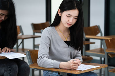 Young woman sitting on table