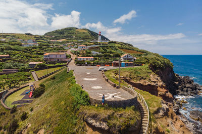 High angle view of sea and mountain against sky