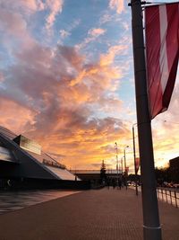 Bridge over street against sky during sunset