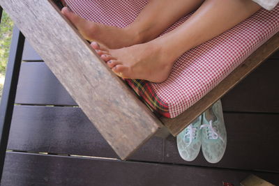 Low section of woman sitting on seat