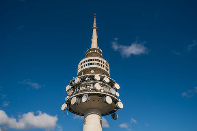 Low angle view of communications tower against sky