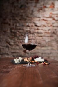 Close-up of wine on table against wall