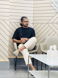 Portrait of young man sitting on chair