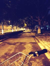 Bicycle parked on road at night