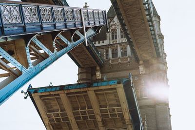 Low angle view of bridge and buildings against sky