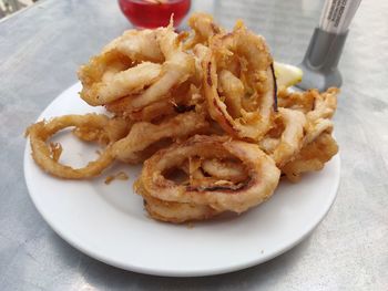 High angle view of bread and fries in plate on table