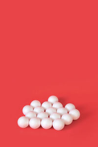 High angle view of eggs against red background