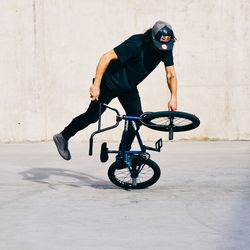 Man riding bicycle on wall