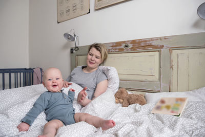 Mother with baby on bed