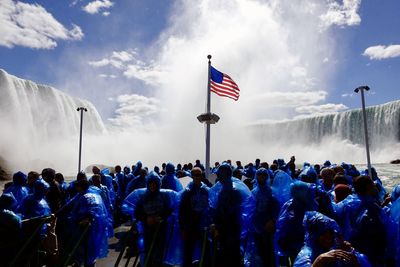 Group of people standing near american flag