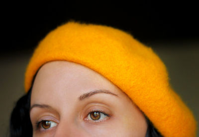 Close-up of thoughtful woman wearing hat