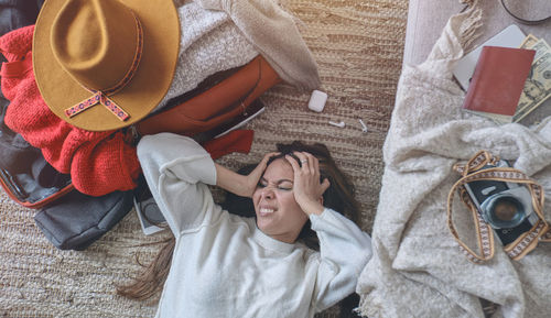 Young woman just arrived in the hotel and stressed at the floor after a long flight. selective focus