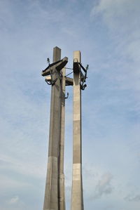 Low angle view of cross against sky