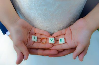 High angle view of couple holding love alphabets