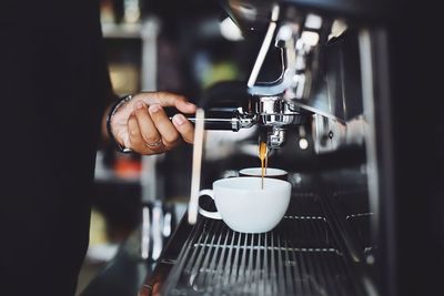 Midsection of man holding coffee