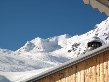 Low angle view of snowcapped mountains against sky