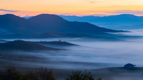 Scenic view of mountains against sky during sunset