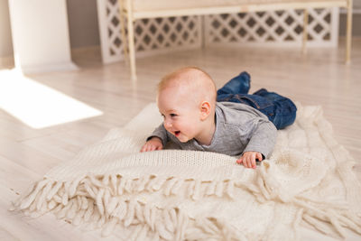 Cute boy lying on bed at home