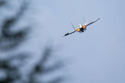 Low angle view of drone flying against sky