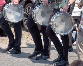 Low section of marching band with drums on street during parade