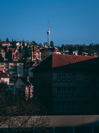 Buildings in city against clear blue sky