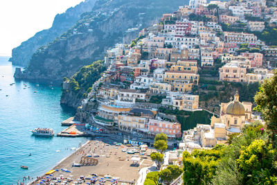 High angle view of buildings by sea