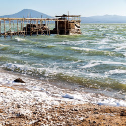 Built structure on beach against sky