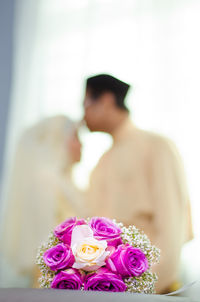 Close-up of couple holding bouquet