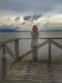 Rear view of man standing on pier