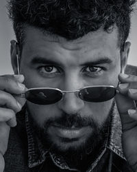 Close-up portrait of young man wearing sunglasses