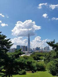 View of buildings in city against cloudy sky