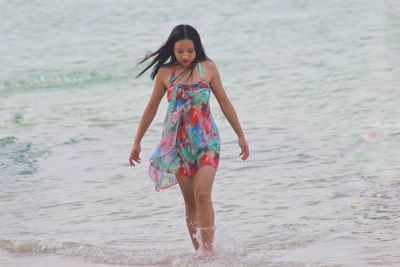 Portrait of young woman standing on beach