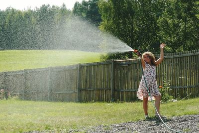 Young woman standing on grass