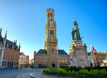 Statue of buildings against blue sky