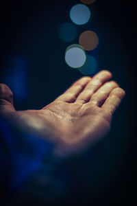 Close-up of hands over black background