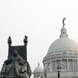 Low angle view of statue of building against clear sky