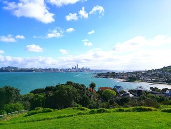 Scenic view of sea and buildings against sky