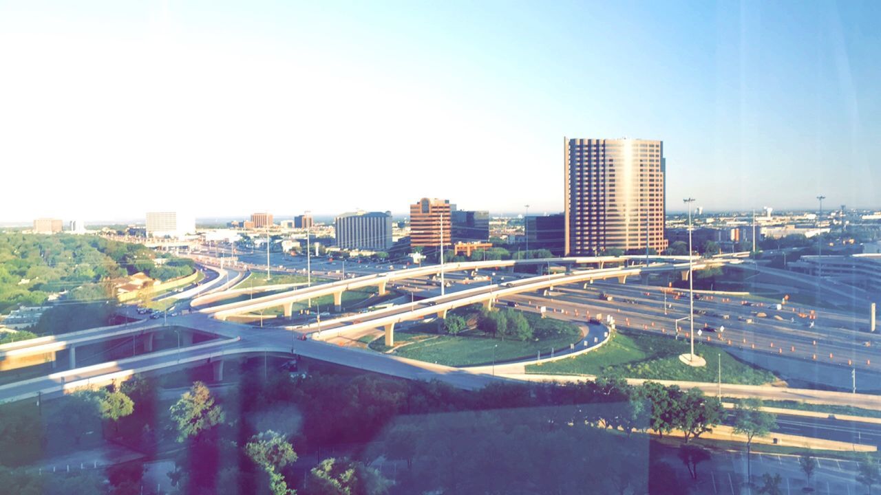 clear sky, building exterior, architecture, built structure, copy space, city, blue, cityscape, high angle view, residential structure, residential building, transportation, road, residential district, street, building, day, outdoors, city life, sky