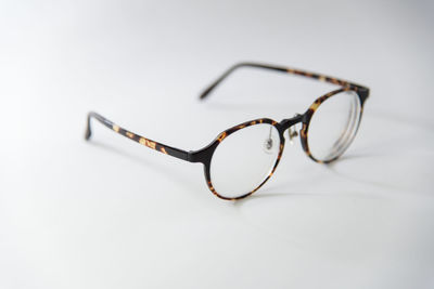 Close-up of sunglasses on table against white background