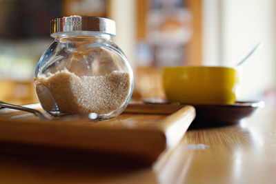 Close-up of brown sugar in jar on table