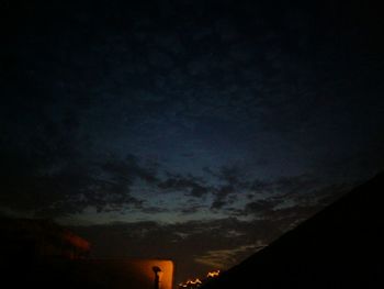 Silhouette of mountain against dramatic sky