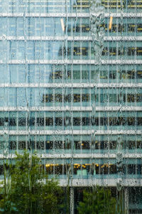 Building seen through wet window during rainy season