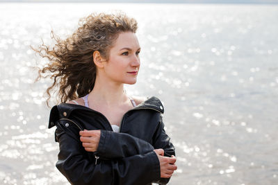 Woman portrait, woman looking to the side on the shore