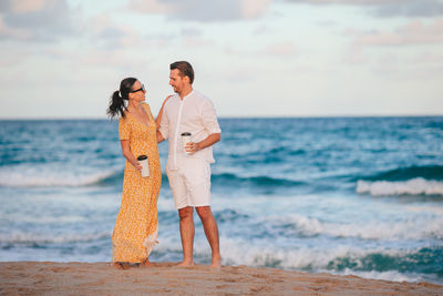 Full length of woman standing at beach
