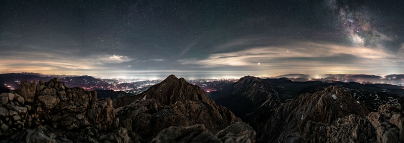 Scenic view of mountains against sky at night