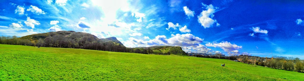 sky, tranquil scene, mountain, blue, landscape, tranquility, scenics, grass, beauty in nature, nature, cloud - sky, cloud, non-urban scene, green color, mountain range, idyllic, sunlight, remote, rock formation, day