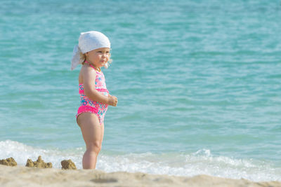 Side view of girl standing at beach