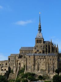 Low angle view of historic building against blue sky