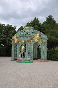 View of closed gate against cloudy sky