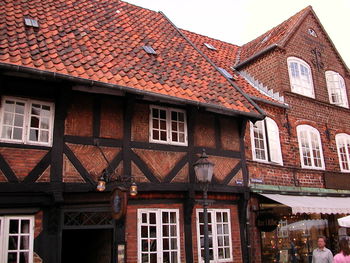 Low angle view of old building in town against sky